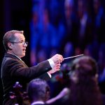 Ryan Murphy, associate music director, conducts The Tabernacle Choir and Orchestra at Temple Square during the 2022 summer concert in the Conference Center on Temple Square in Salt Lake City. (Intellectual Reserve, Inc.)