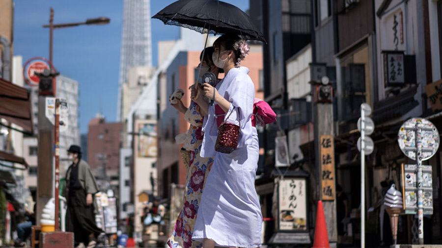 TOKYO, JAPAN - JUNE 29: Women in rental kimonos walk through the Asakusa area on June 29, 2022 in T...