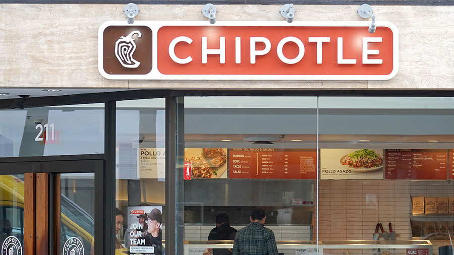 SAN FRANCISCO, CALIFORNIA - APRIL 26: A customer orders food at a Chipotle restaurant on April 26, ...