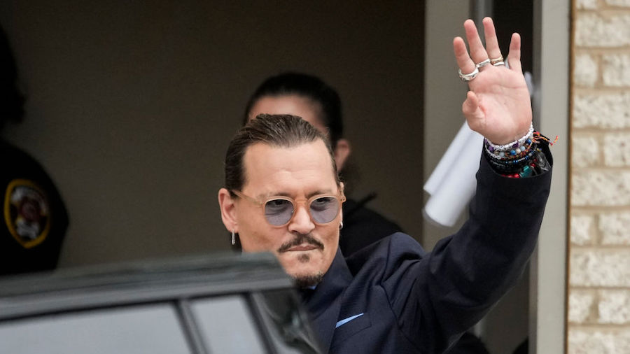 Actor Johnny Depp waves to fans as he departs the Fairfax County Courthouse on May 27, 2022 in Fair...