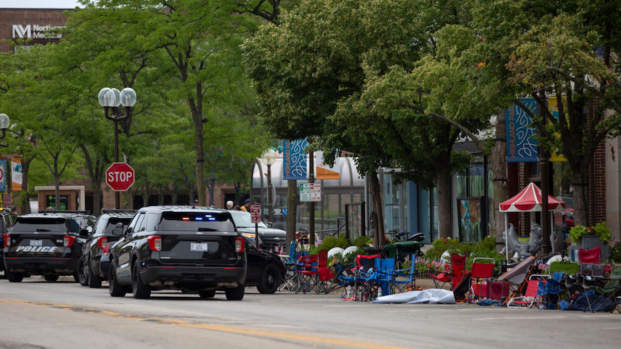 First responders work the scene of a shooting at a Fourth of July parade on July 4, 2022 in Highlan...