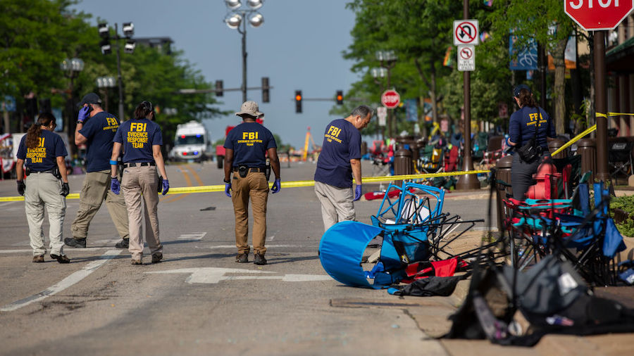 FBI agents work the scene of a shooting at a Fourth of July parade on July 5, 2022 in Highland Park...