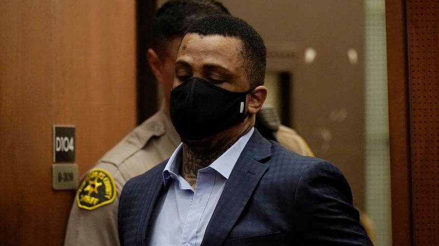 Eric Holder Jr., who is accused of killing  rapper Nipsey Hussle, enters a courtroom to hear the ve...