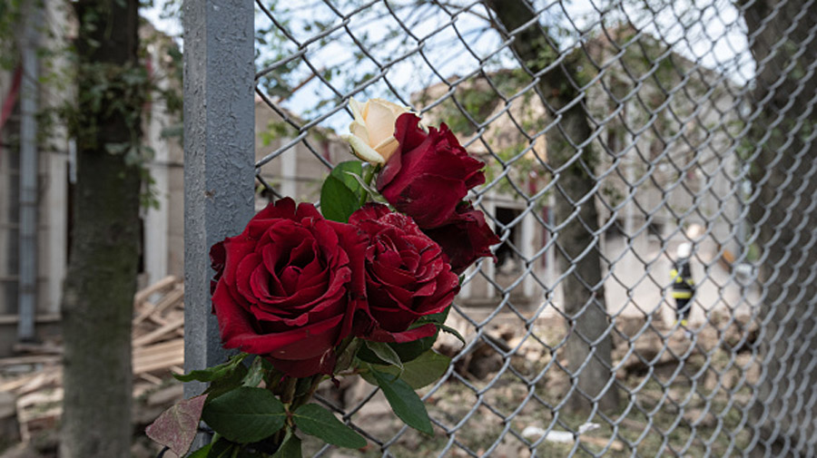 VINNYTSIA, UKRAINE - JULY 15: Roses are attached to a fence next to the heavily damaged building on...