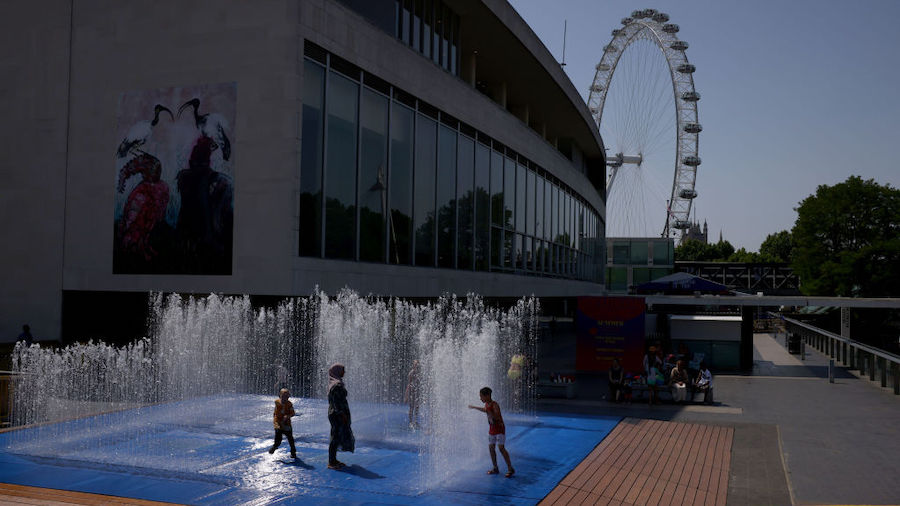 Kids cool themselves in a fountain outside the Queen Elizabeth Hall on July 19, 2022 in London, Uni...