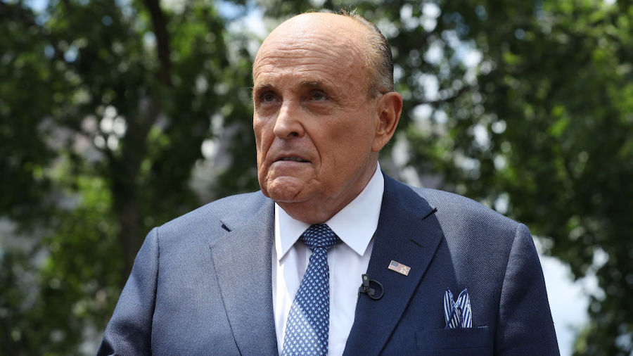 FILE: President Donald Trump's lawyer and former New York City Mayor Rudy Giuliani talks to journal...
