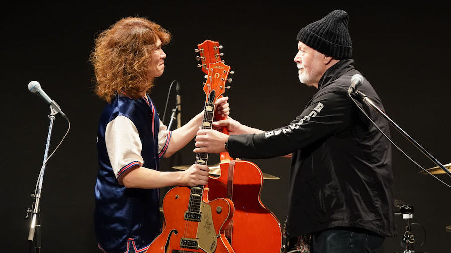 Japanese musician Takeshi (L) and Canadian musician Randy Bachman (R) exchange guitars on July 01, ...