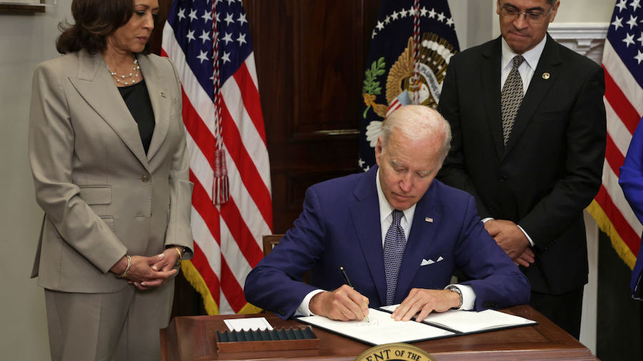 President Joe Biden signs an executive order on access to reproductive health care services as (L-R...