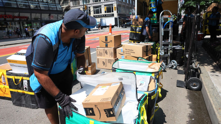 Amazon workers sort packages for delivery on E 14th Street on July 12, 2022 in New York City. Amazo...