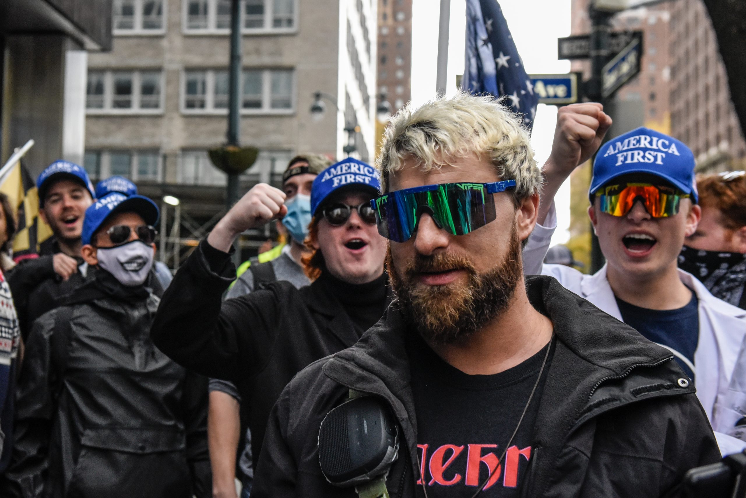 Far right livestreamer Baked Alaska (C) is cheered on by people associated with the far-right group...