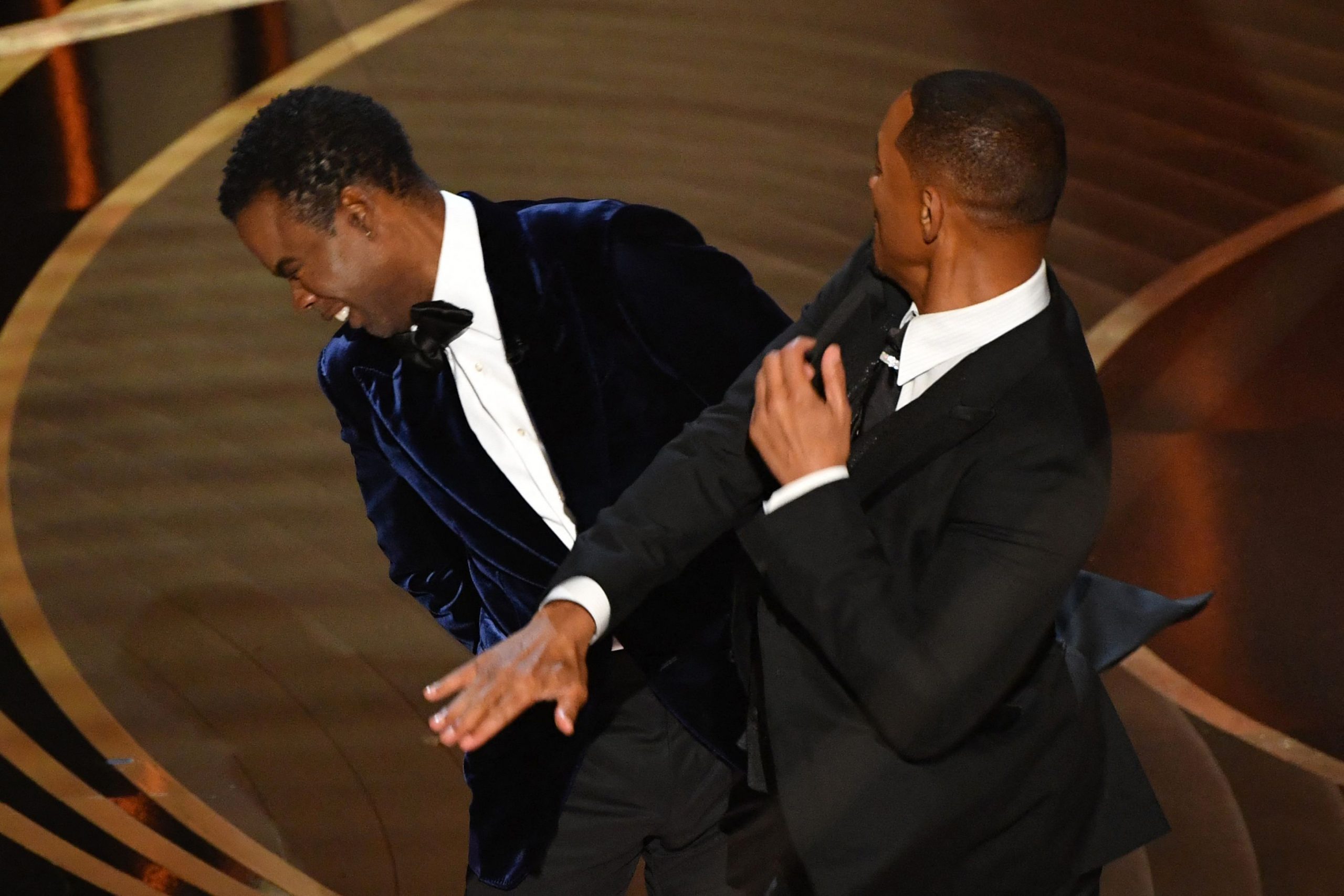 TOPSHOT - US actor Will Smith (R) slaps US actor Chris Rock onstage during the 94th Oscars at the D...