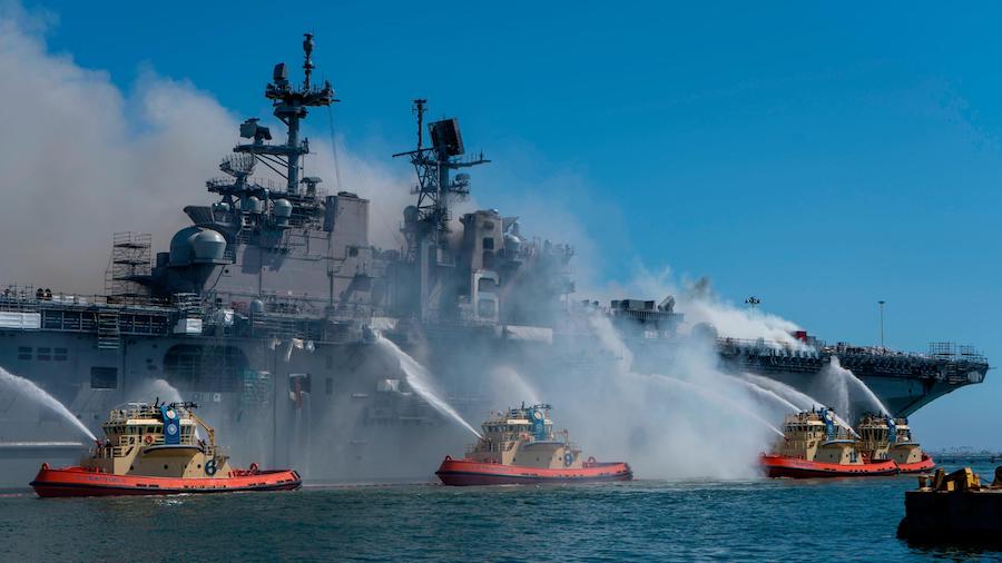 Sailors and Federal Firefighters combat a fire onboard the amphibious assault ship USS Bonhomme Ric...