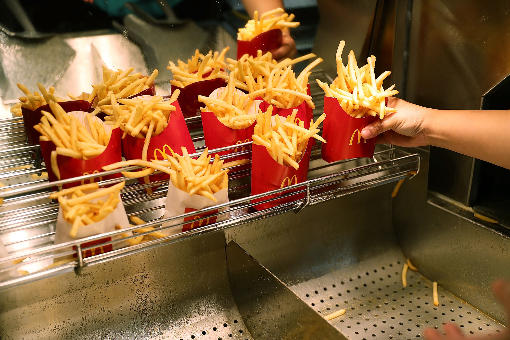 MIAMI, FL - APRIL 25:  McDonald's crew member Samantha Medina prepares french fries as the McDonald...