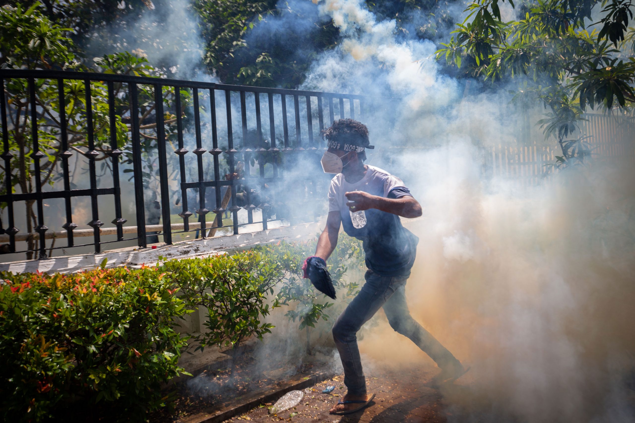 COLOMBO, SRI LANKA - JULY 13: A protestor runs for cover from a tear gas canister fired by army per...