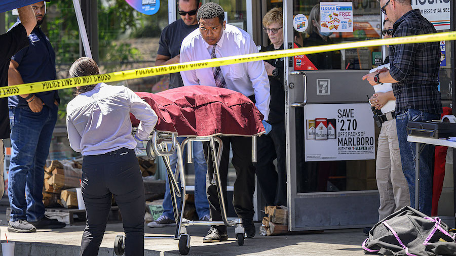 A body is removed from a Brea, California, 7-Eleven after a clerk was fatally shot on July 11. (Min...