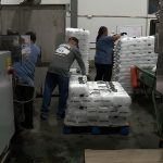 Workers stack bags of ice at Mountain Brand Ice. (KSL TV)