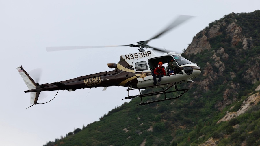A search and rescue member is brought off the mountain by the DPS helicopter. (Scott G. Winterton/D...
