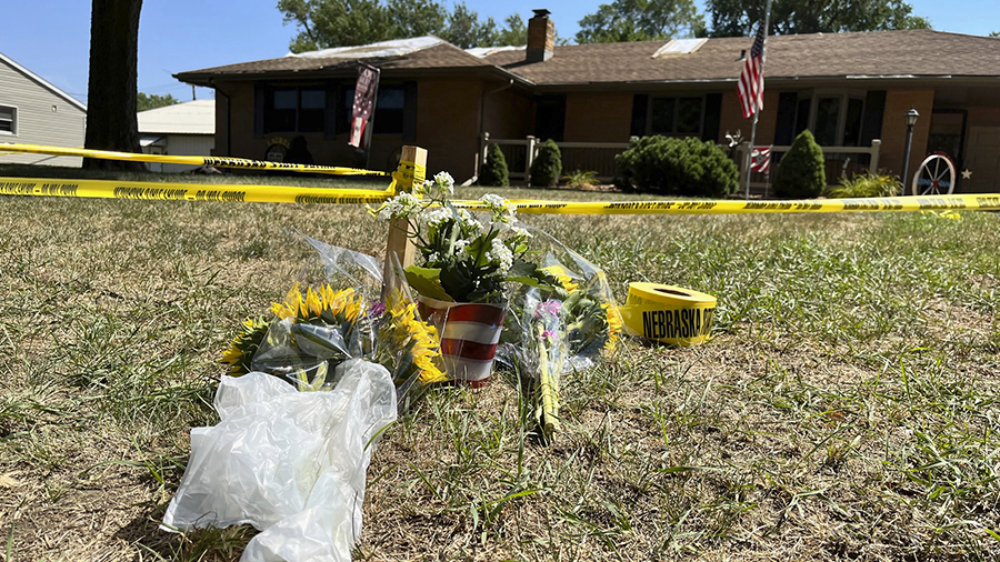 A small memorial sits outside the home of Gene Twiford, 86, Janet Twiford, 85, and Dana Twiford, 55...