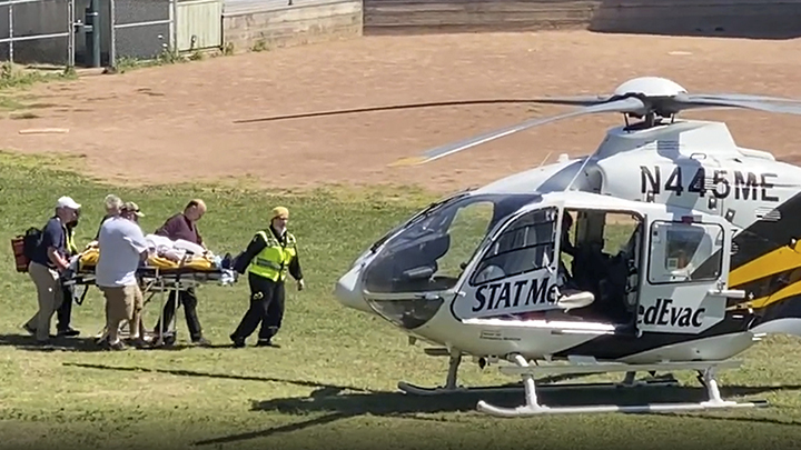 In this still image from video, author Salman Rushdie is taken on a stretcher to a helicopter for t...