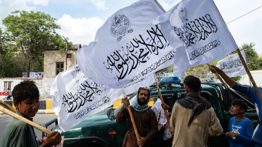 Men sell flags of the Islamic Emirate of Afghanistan (Taliban) on August 14, 2022 in Kabul, Afghani...