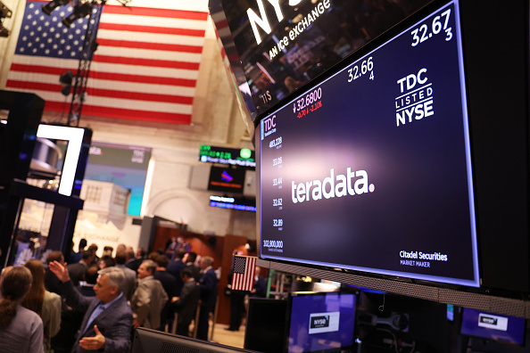 NEW YORK, NEW YORK - AUGUST 29: The Teradata company logo is seen on a screen as traders work on th...