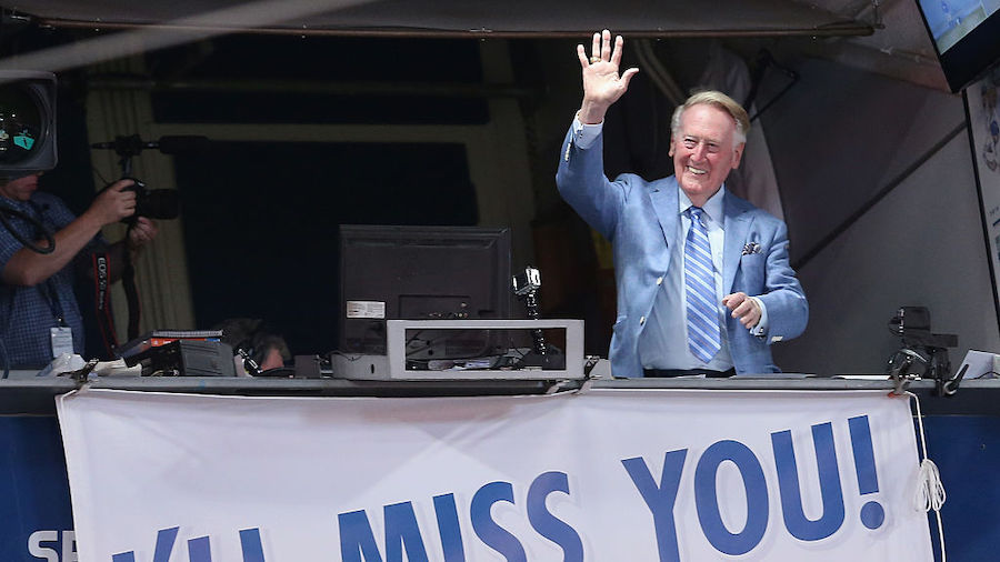 Los Angeles Dodgers broadcaster Vin Scully waves to the crowd after leading in the singing of Take ...