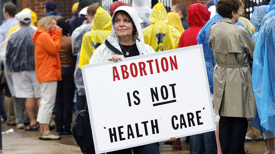 ANN ARBOR, MI - MAY 1:  A protestor holds up an anti abortion sign outside the University of Michig...