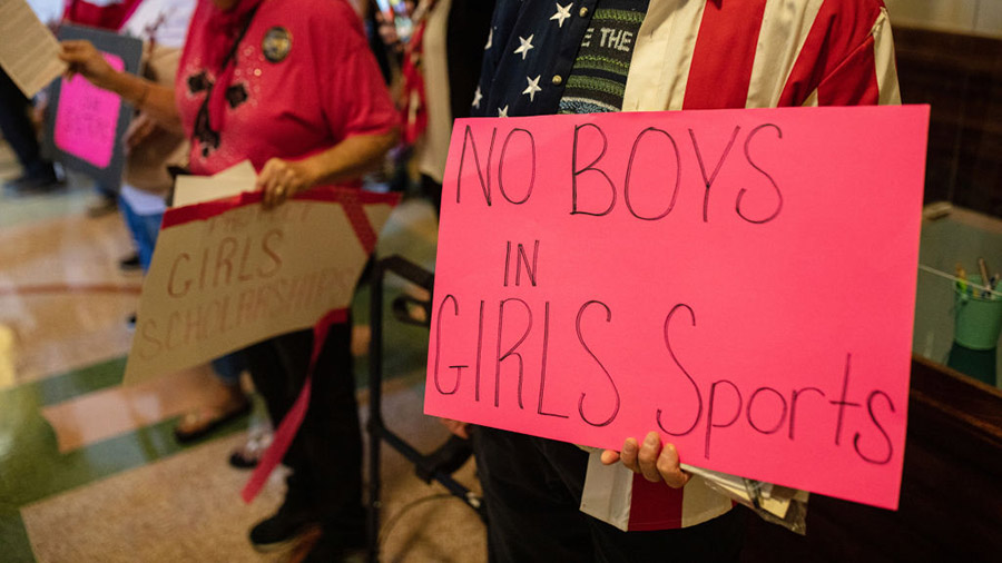 AUSTIN, TX - SEPTEMBER 20: Demonstrators supporting restrictions on transgender student athletes ar...