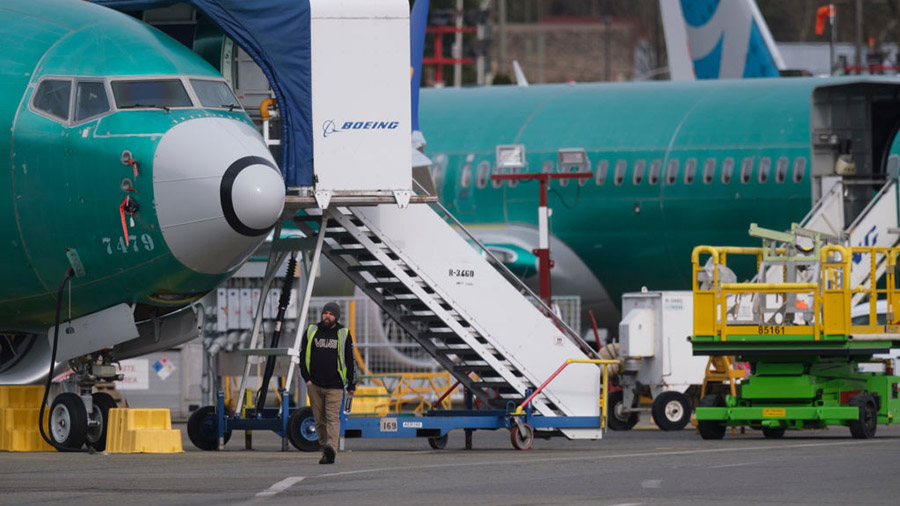 RENTON, WA - MARCH 14: An employee walks past a Boeing 737 MAX 9 at Renton Municipal Airport outsid...