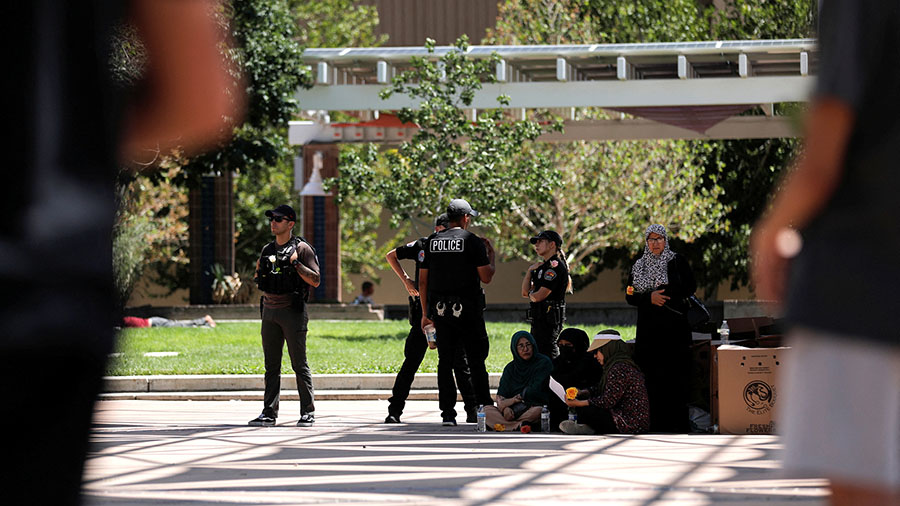 Members of the Albuquerque Police Department standby during a unity event following the murders of ...