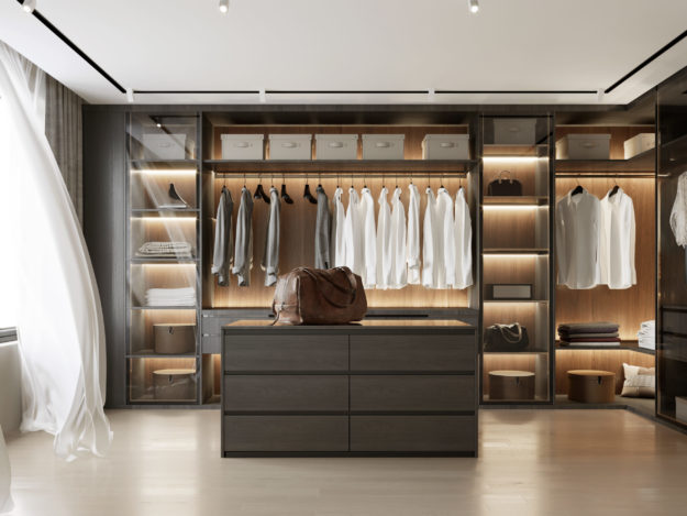 organized walk in closet with white curtain and leather briefcase