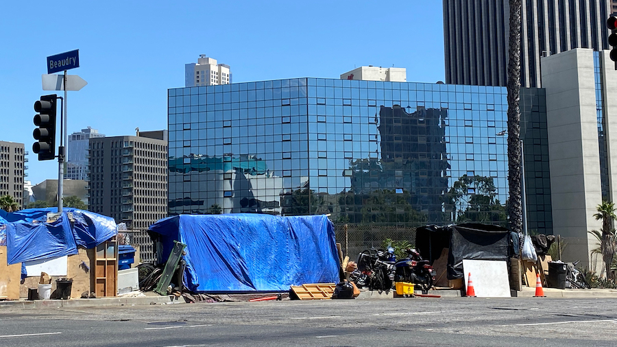 A homeless encampment with the LA Grand hotel seen in the background. (Stephanie Becker/CNN)...
