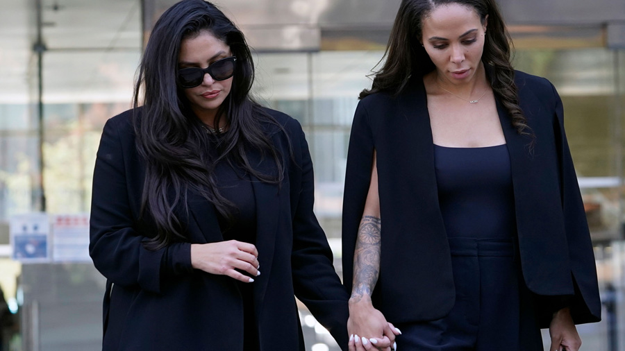 Vanessa Bryant, left, the widow of the late Kobe Bryant, holds hands with friend, Sydney Leroux as ...