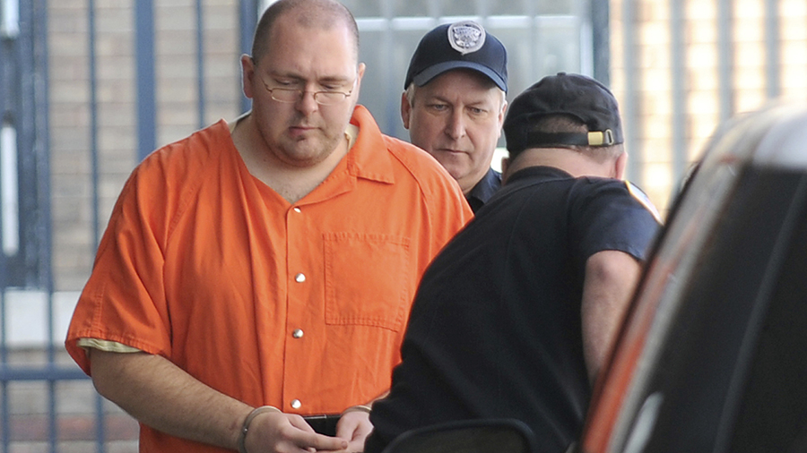 FILE - Michael Carneal, 27, is escorted by a guard from the U.S. District Courthouse in Paducah, Ky...