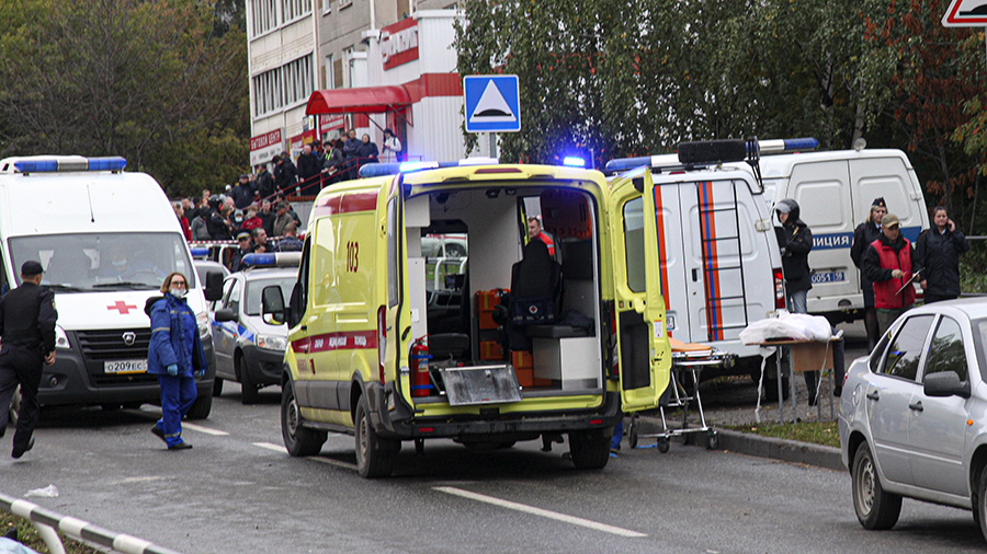 Police and paramedics work at the scene of a shooting at school No. 88 in Izhevsk, Russia, Monday, ...