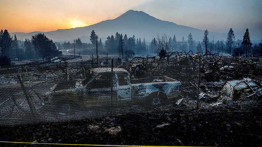 The sun rises over Mt. Shasta and homes destroyed by the Mill Fire on Saturday, Sept. 3, 2022, in W...