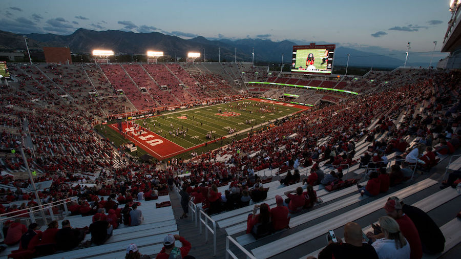 Fans watch as members of the Utah Utes and the San Diego State Aztecs warm up before their game Sep...