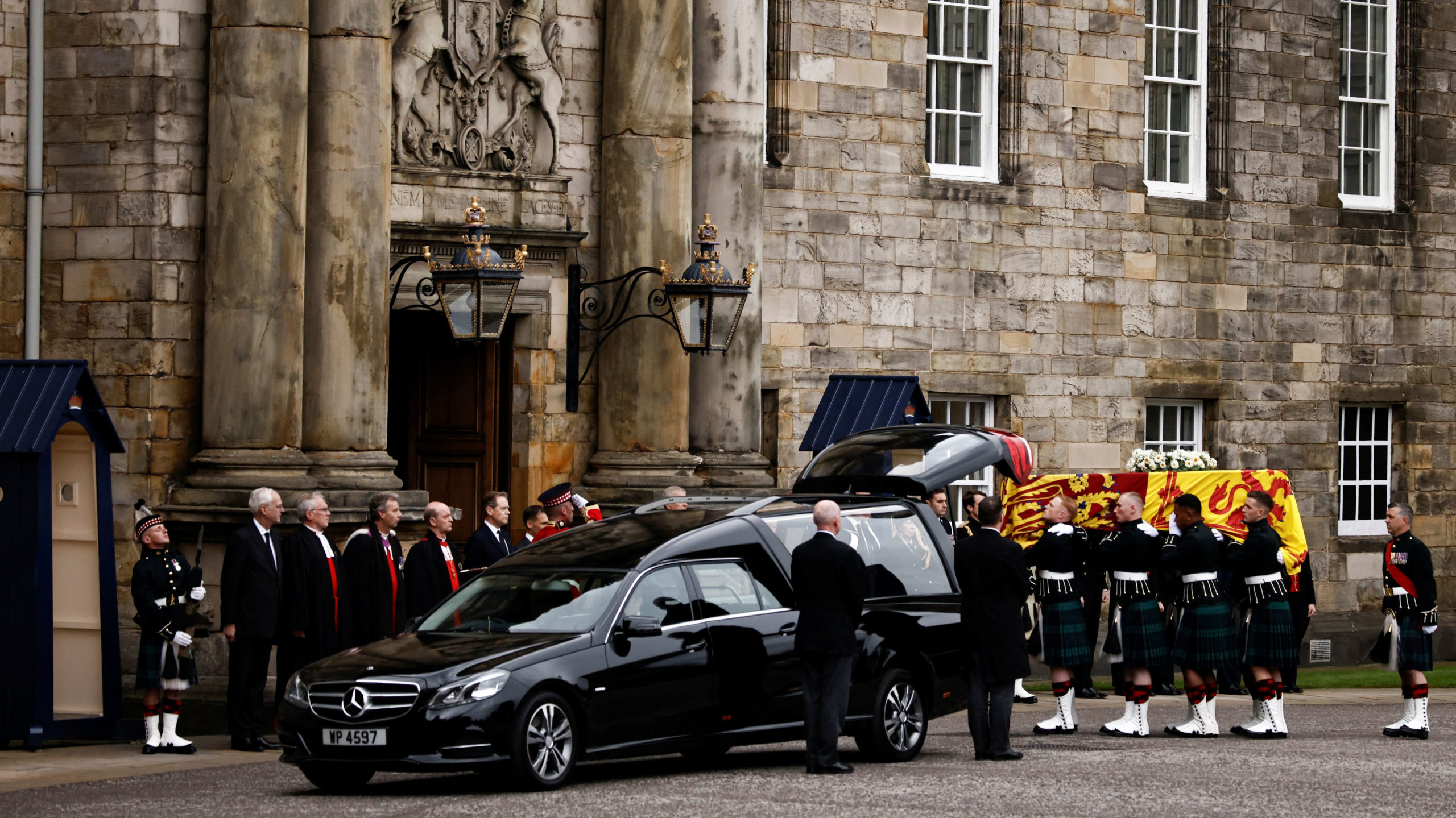 pallbearers carry the Queen's coffin at the Palace of Holyroodhouse...