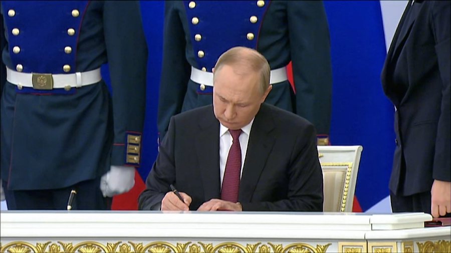 Russian President Vladimir Putin is seen here signing the annexation documents in Moscow on Sept. 3...