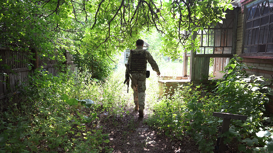 A soldier with Ukraine's Territorial Defense walks up to an abandoned home on June 29, 2022 in the ...
