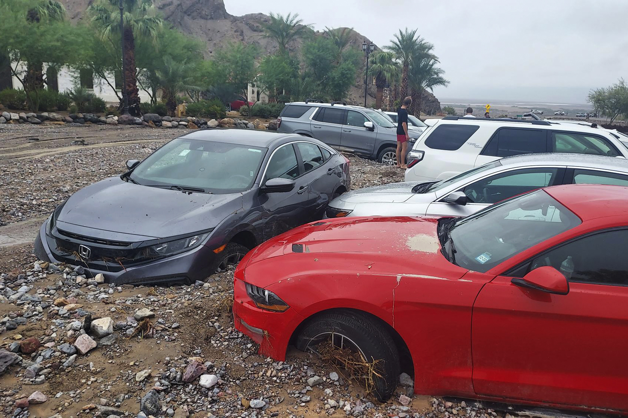 In this photo provided by the National Park Service, cars are stuck in mud and debris from flash fl...