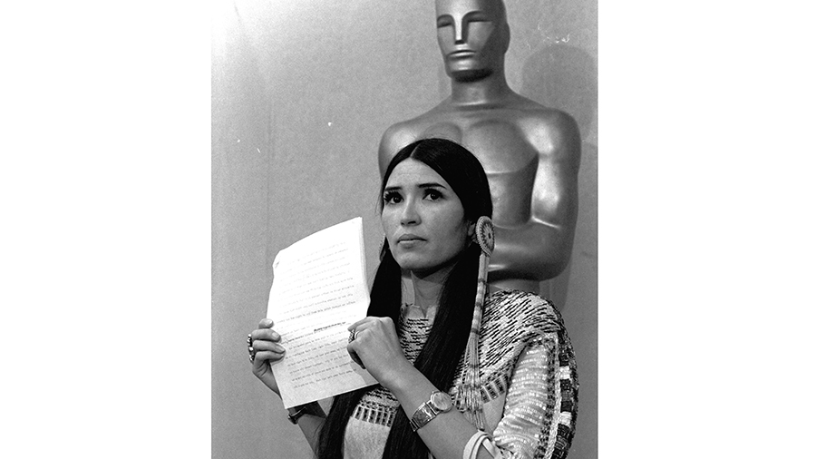 FILE - Sacheen Littlefeather, a Native American activist, tells the audience at the Academy Awards ...