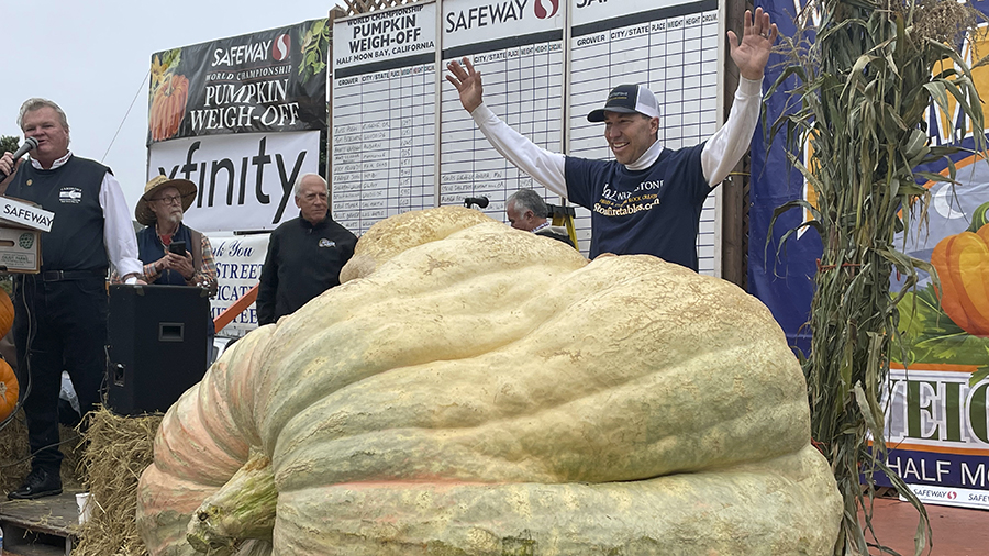 Travis Gienger from Anoka, Minn., stands behind his winning pumpkin at the 49th World Championship ...