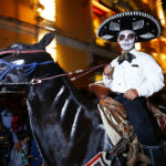 A man dressed as a "charro" and a skeleton on horseback participates during the parade of the "Day Of The Dead Festival" in Guanajuato as part of the 2021 'Day of The Dead' celebration on November 1, 2021 in Guanajuato, Mexico. (Leopoldo Smith/Getty Images)
