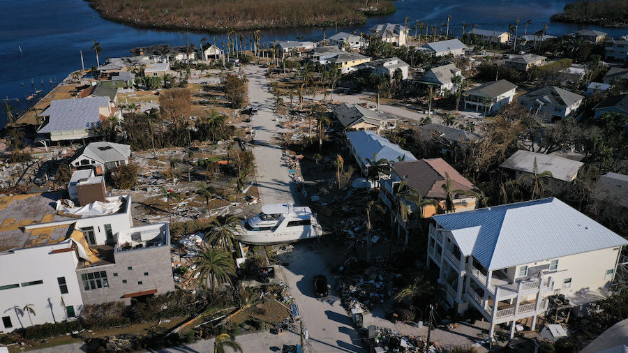 In this aerial view, a yacht sits in the front yard of a home In the wake of Hurricane Ian on Octob...