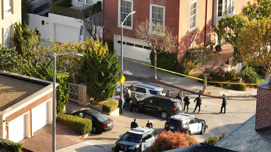 In an aerial view, San Francisco police officers and F.B.I. agents gather in front of the home of U...