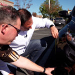 KSL’s Matt Gephardt takes measurements of the damage on the car. (KSL TV)