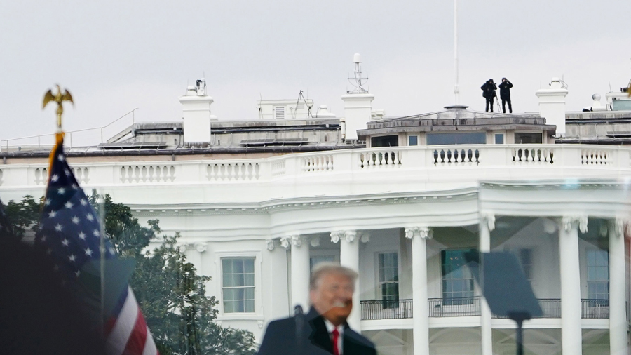 Members of the Secret Service patrol from the roof of the White House as US President Donald Trump ...