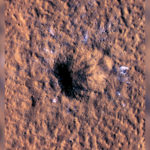 Boulder-size ice chunks can be seen scattered around and outside the new crater's rim.(NASA/JPL-Caltech/University of Arizona)