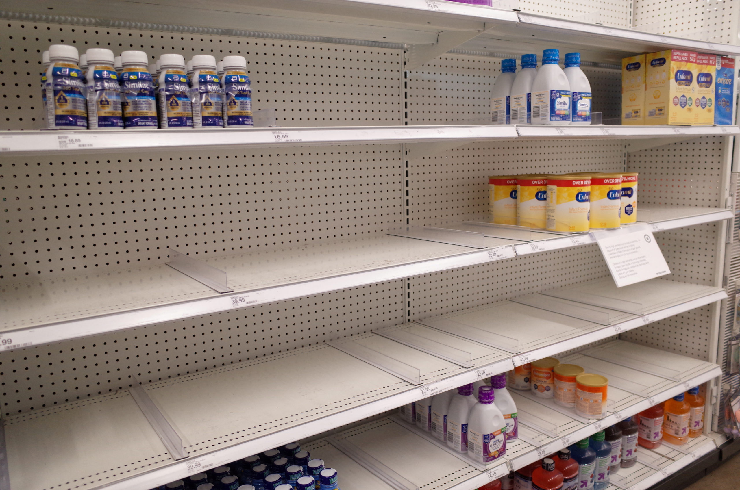 FILE PHOTO: Similac and Enfamil products are seen on largely empty shelves in the baby formula sect...